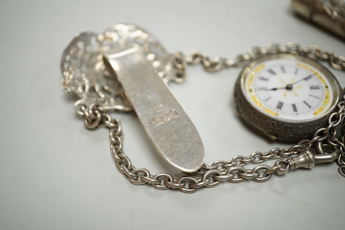 An Edwardian pierced silver chatelaine, by Samuel Jacob, London, 1902, with three accoutrements to include two silver cases and a enamelled fob watch, overall length 34cm.